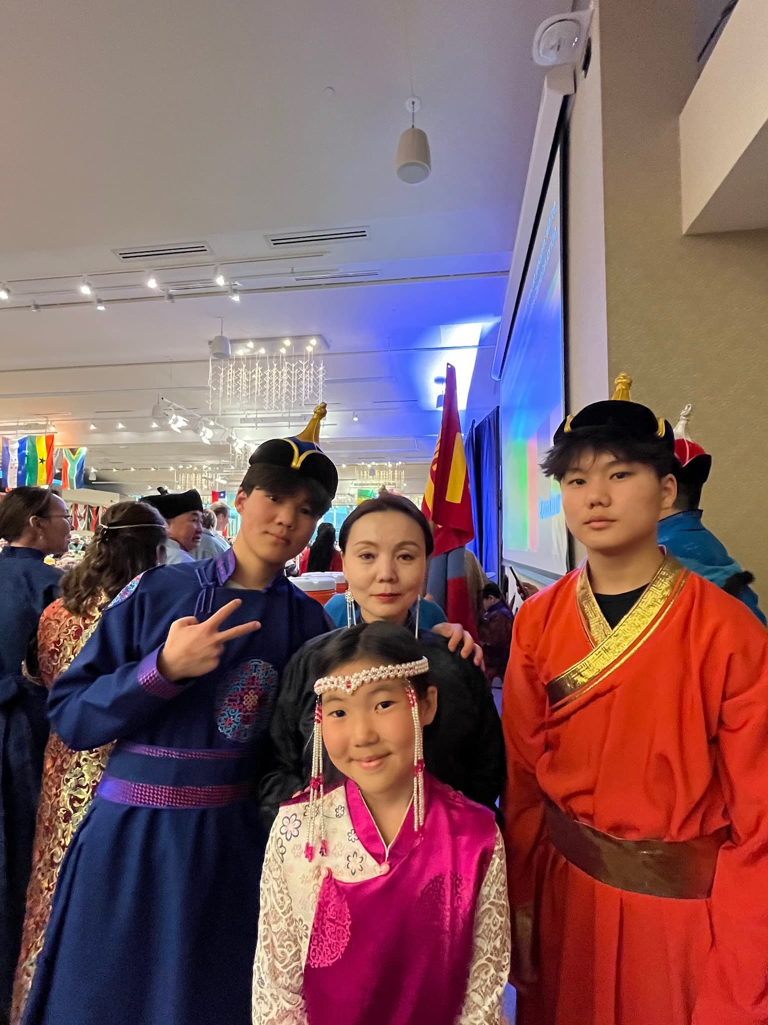 Eric at the right in a red deel and black hat, with family and other performers at the World Unity Fair.