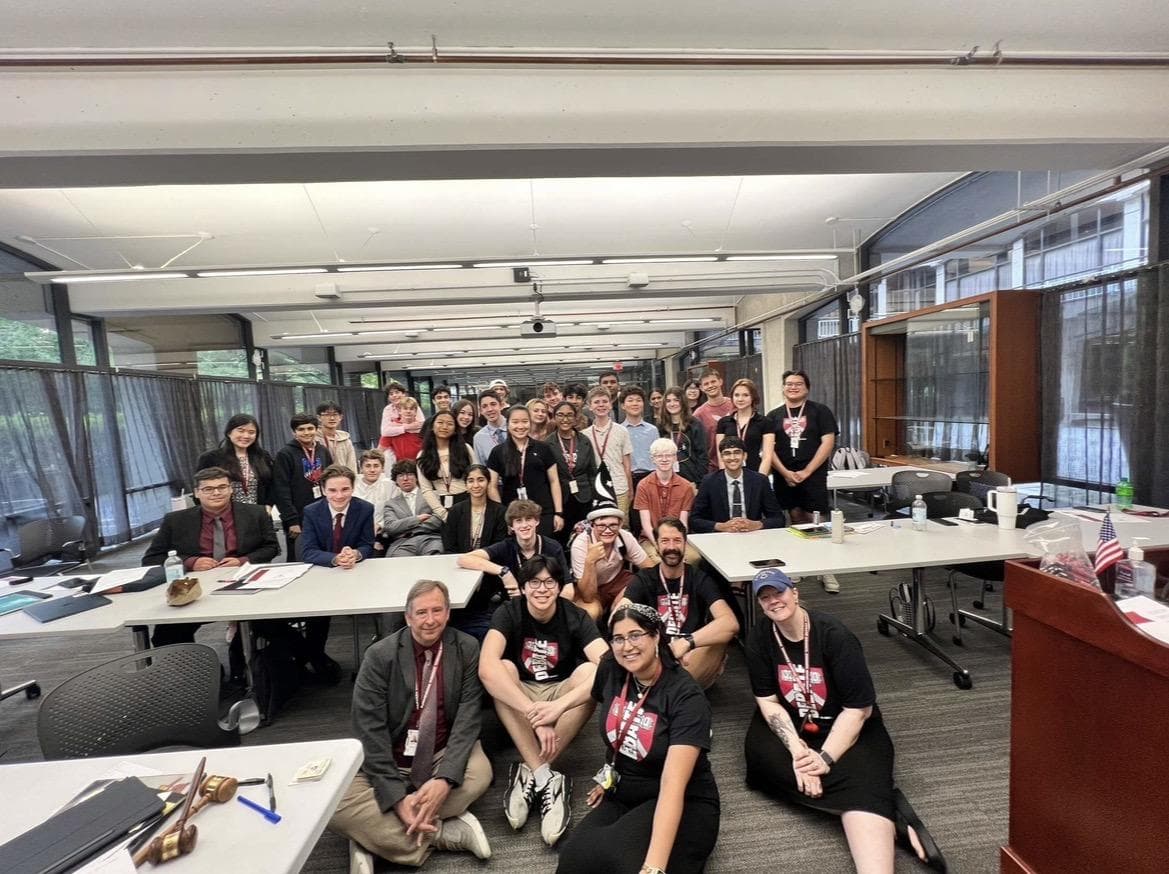 A large group from the Harvard Debate Council Summer Workshop gathered in a bright seminar room.